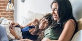 Two women infront of a notebook